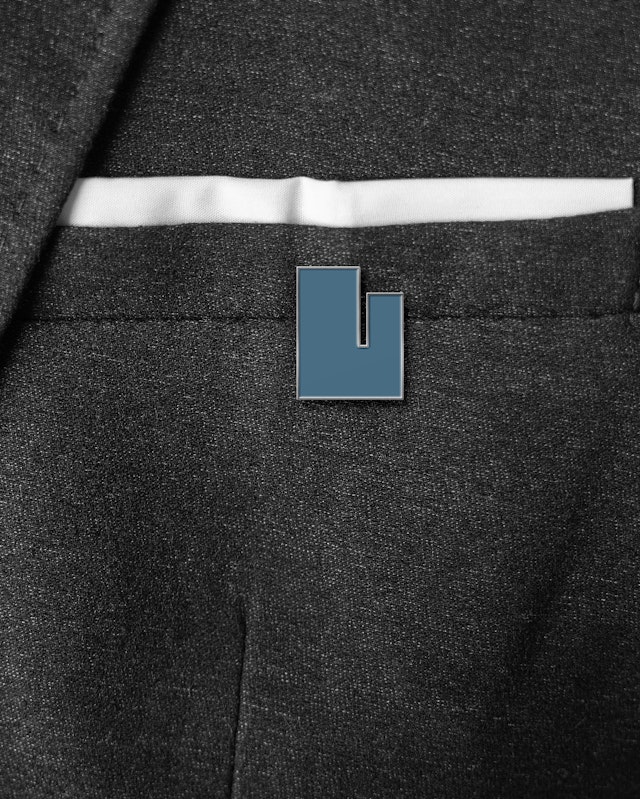 Designs for a lapel pin and tote bag.