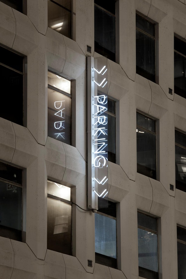 Neon signage installed on the exterior of the garage at 13-17 East 54th Street.