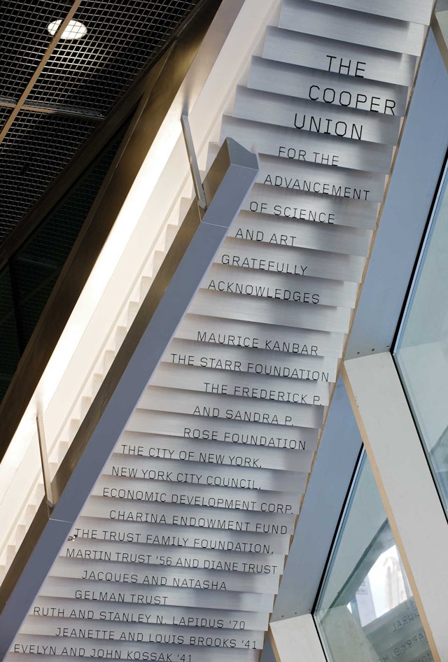 Donor signage cascades down the underside of a lobby staircase.