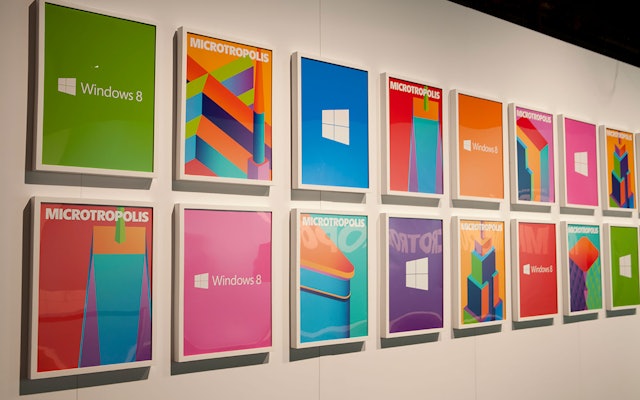 The forms of the logo echoed in a poster arrangement at the show.