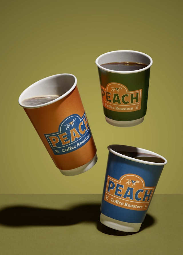 Peach coffee cups in three new brand colors.