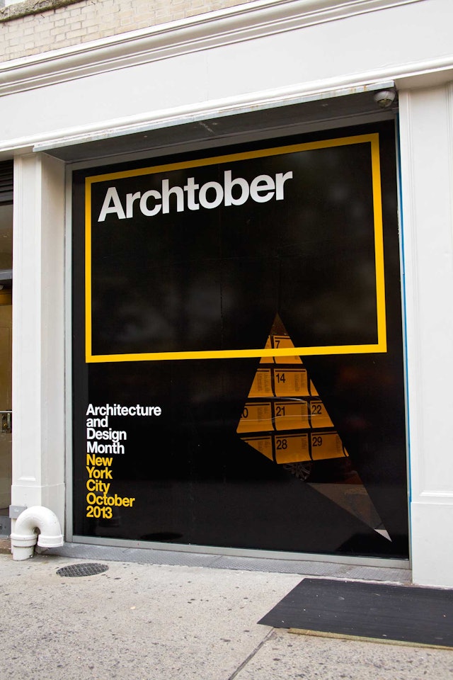 The storefront of the Center for Architecture has been blacked out except for a triangle cutout.