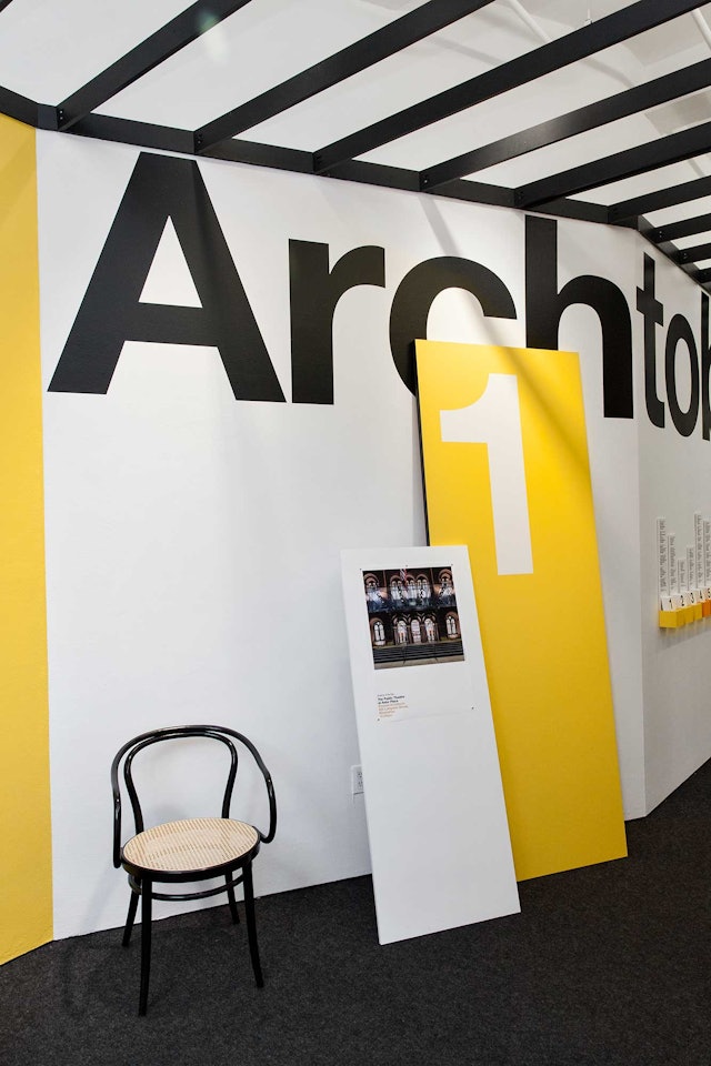 Leaning wall panels display the numerical date and the Building of the Day.