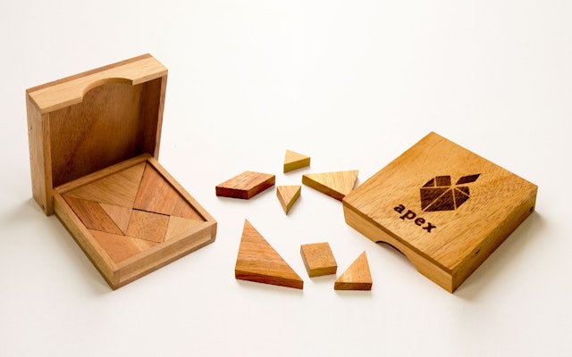 The new identity is introduced with a wooden tangram puzzle.