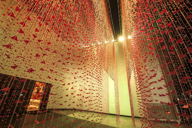 The triangles have been arranged into curtains, which are hung in front of the store