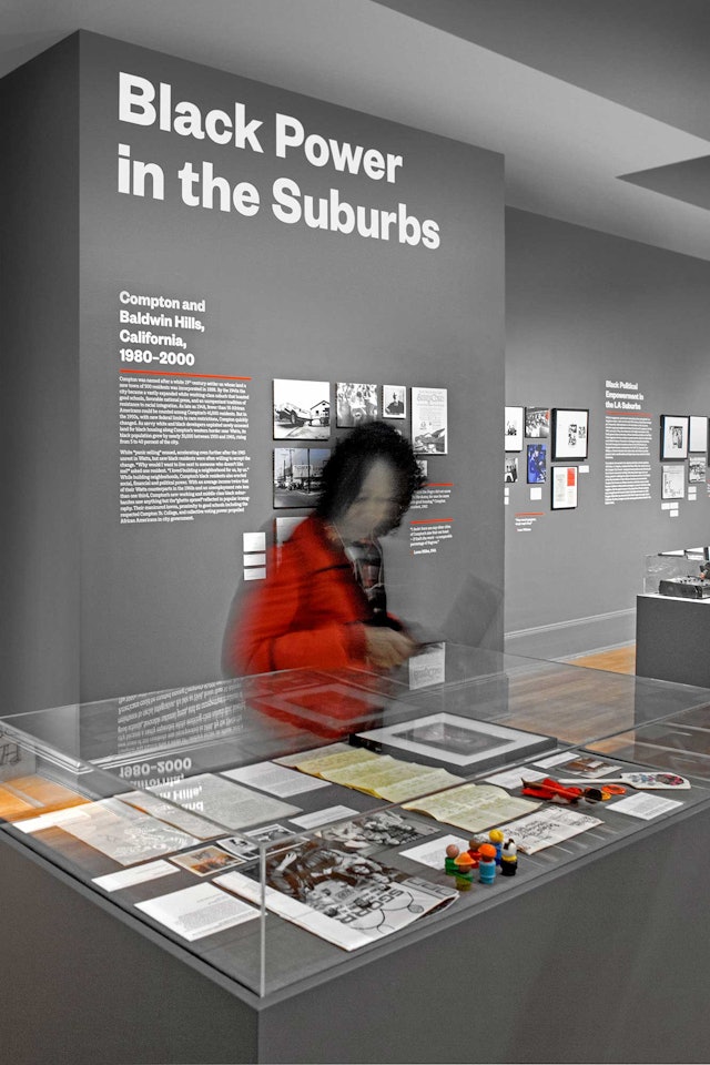 Archival artifacts are displayed throughout the exhibition.