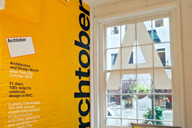 Graphics applied to a yellow brick wall at Archtober Hall.