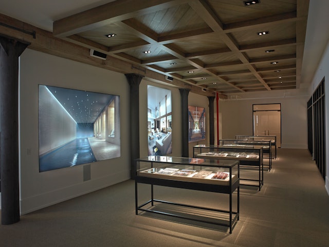 The gallery features custom vitrines with exhibits about the building and its materials.