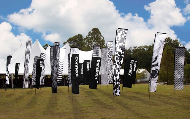 A field of flags feature the conference keywords and custom patterns inspired by networks and techno