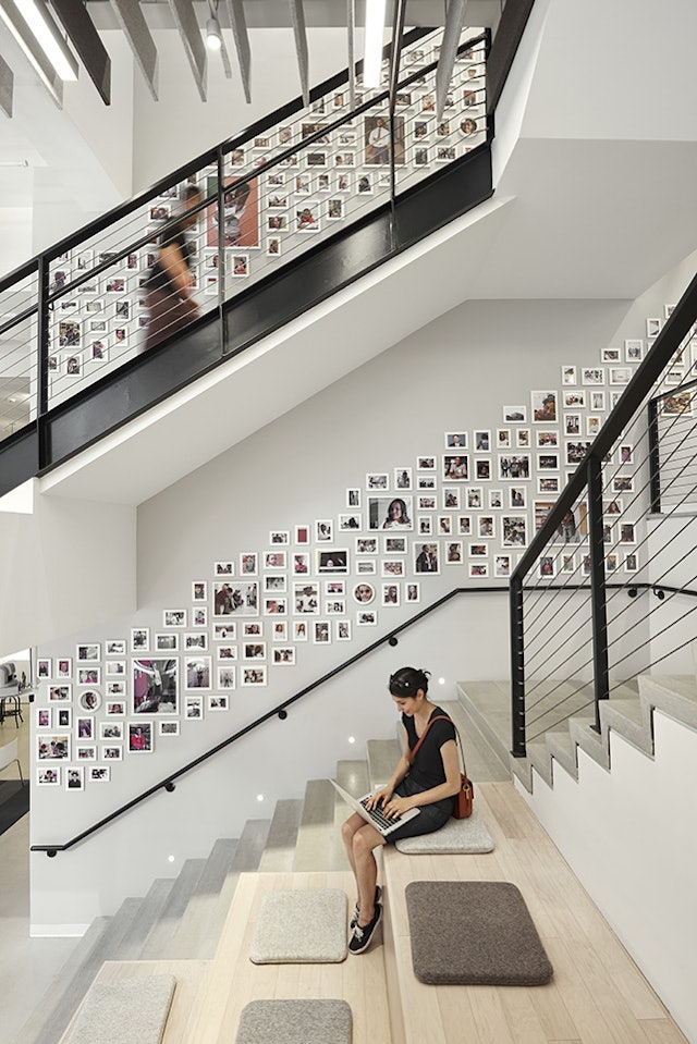 The portraits of corps members and students wrap around the three-story stairwell.