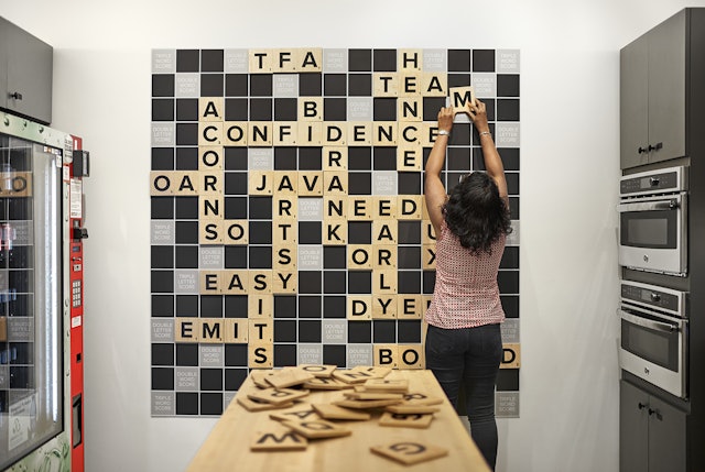 A silkscreened Scrabble board offers a playful break from the workspace.