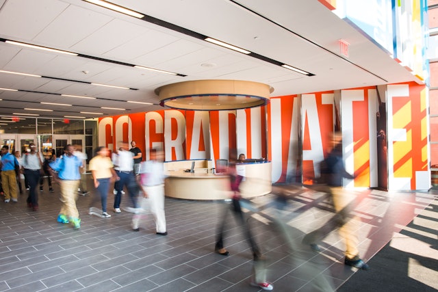 Sawtooth wall in the main lobby features a large-scale message: GO. GRADUATE.