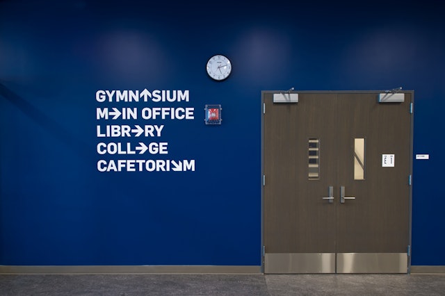 Arrows replace letters in playful wayfinding to key areas in the school.