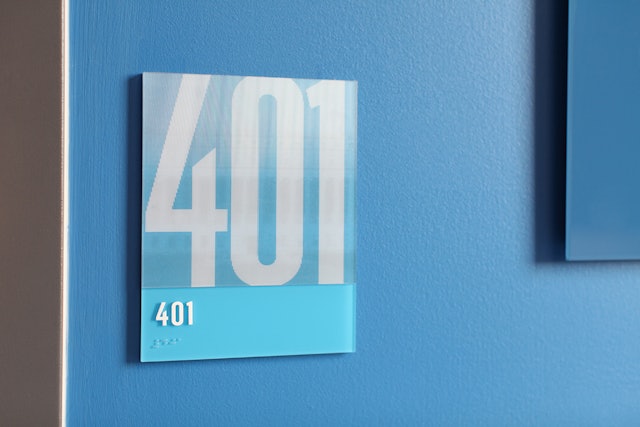 Lenticular classroom signs display the room number from one angle, and images of popular colleges from another.