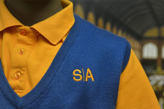 The monogram version of the logo used as insignia on school uniforms.