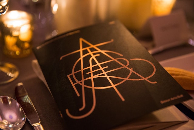 The logo was foil-printed in gold on programs.